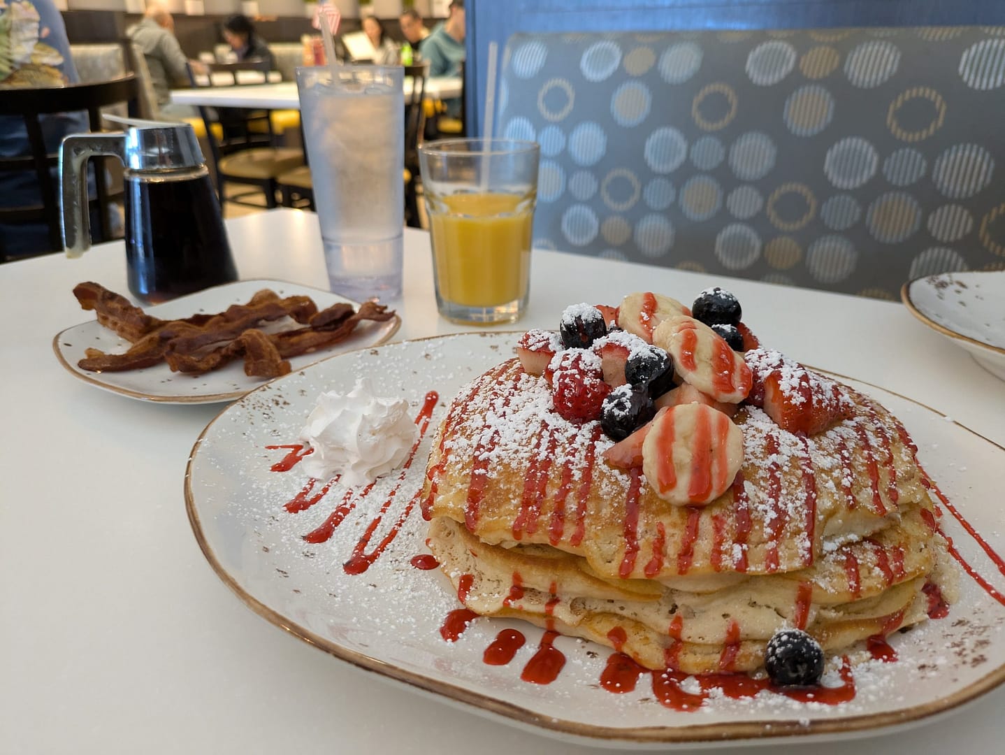 Summer Break Pancakes with strawberries, blueberries, and bananas on top
