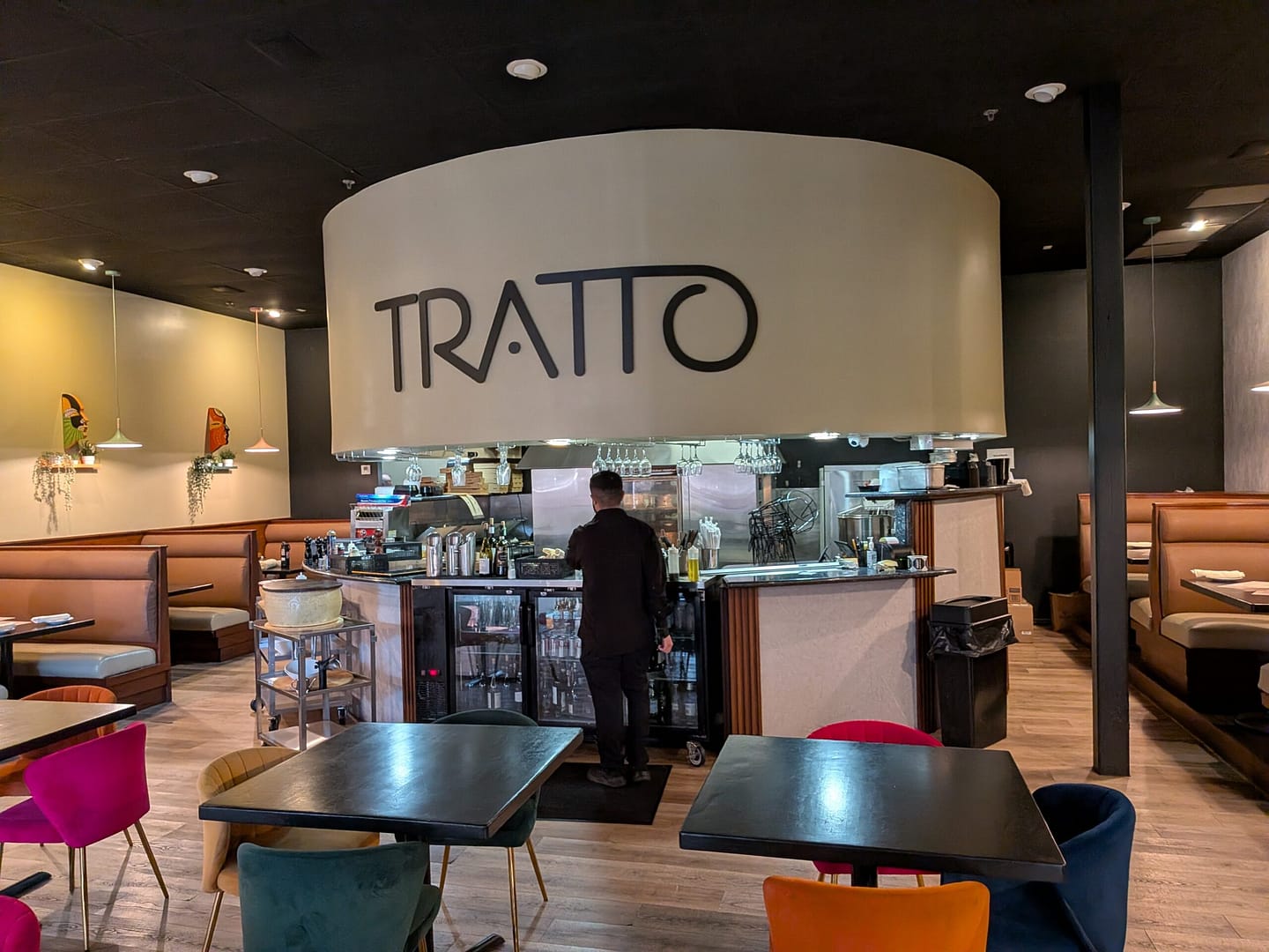 Dining room at Tratto in Avalon Park with open kitchen and TRATTO sign