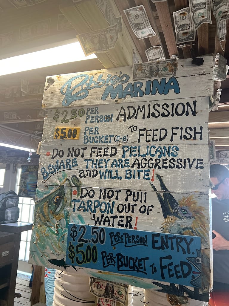 Sign and dollar bills post at Robbie's Marina